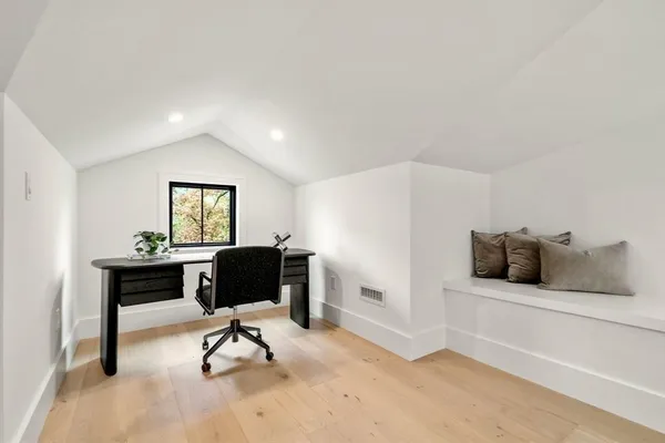 a view of a livingroom with furniture and a window