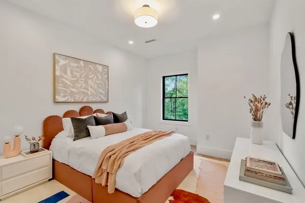 a bedroom with a bed and a window