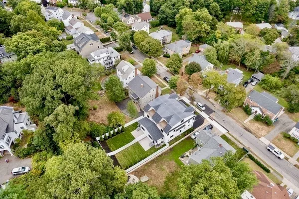 an aerial view of residential houses with outdoor space
