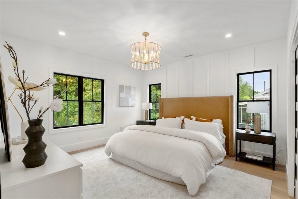 71 Cloverdale Road, Unit 1 Newton, MA 02461 - Photo 28 of 32 a bedroom with a large bed and a window