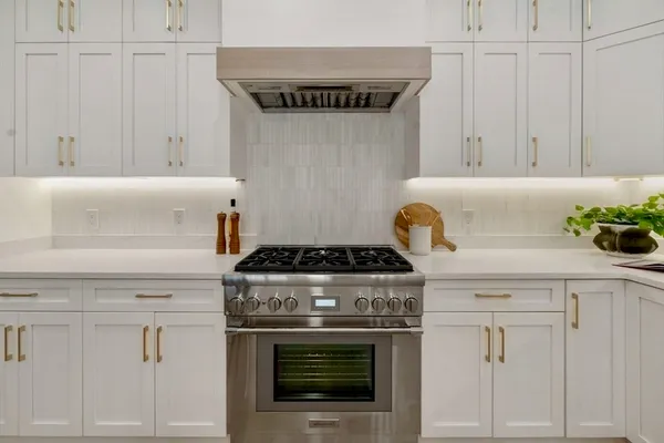 a stove top oven sitting inside of a kitchen