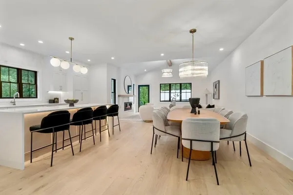 a living room with lots of furniture and a view of a chandelier