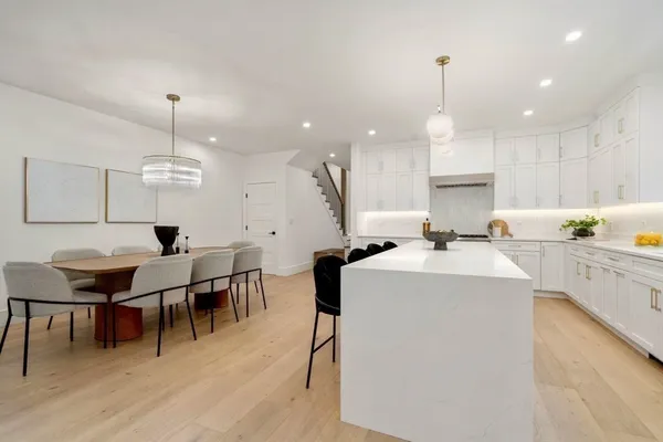 a view of kitchen with cabinets table and chairs