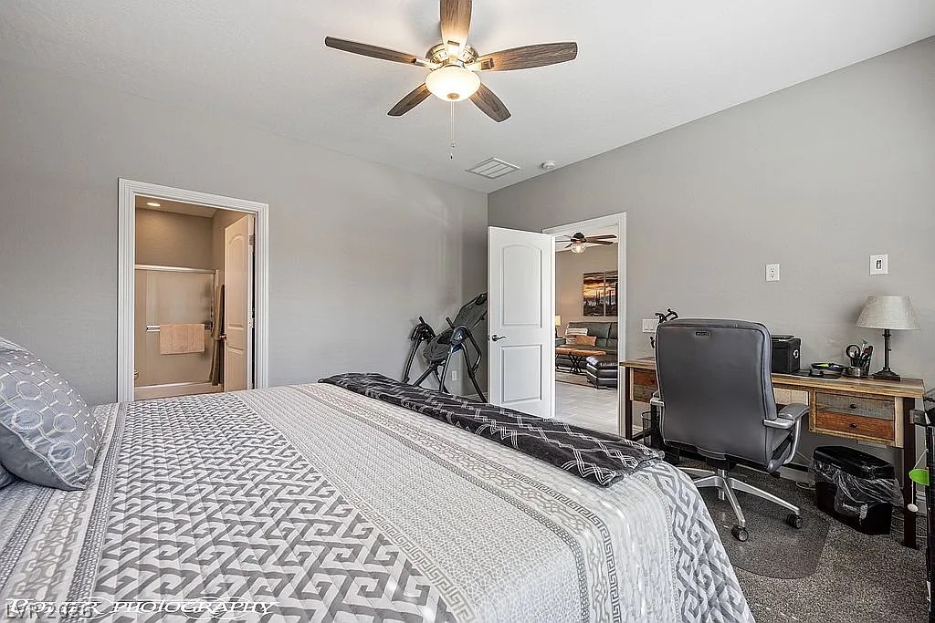 1304 Cottage Ridge Mesquite, NV 89034 - Photo 19 of 52 A restful chamber offers direct access to an en-suite bathroom and an adjacent living area.