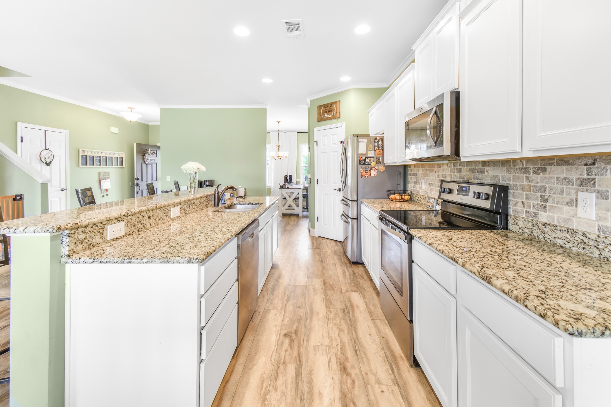 1407 Old Stone Road Lebanon, TN 37087 - Photo 14 of 45 a large kitchen with granite countertop a large counter top appliances and cabinets