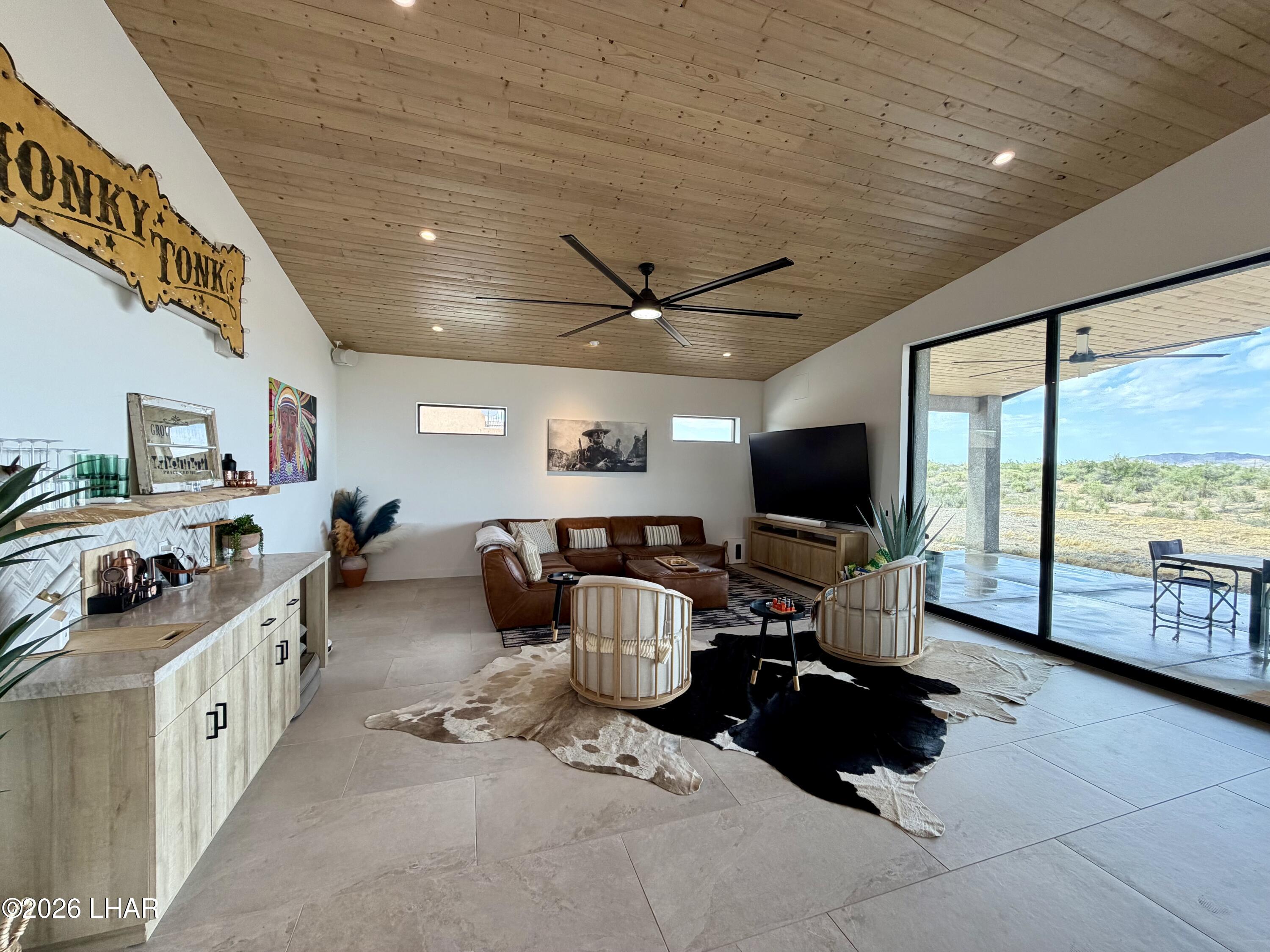48963 Riviera Place Ehrenberg, AZ 85334 - Photo 13 of 58 a living room with furniture and a flat screen tv