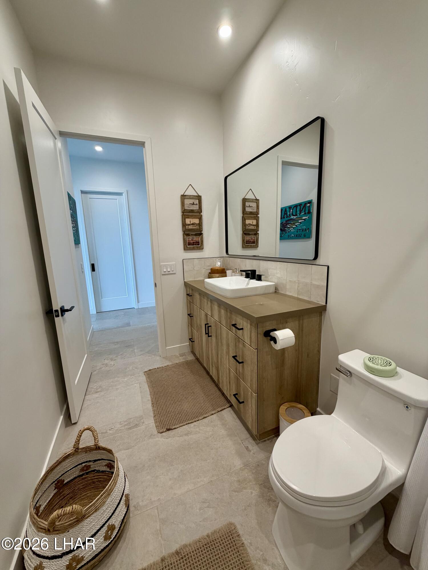 48963 Riviera Place Ehrenberg, AZ 85334 - Photo 28 of 58 a bathroom with a toilet a sink and a mirror