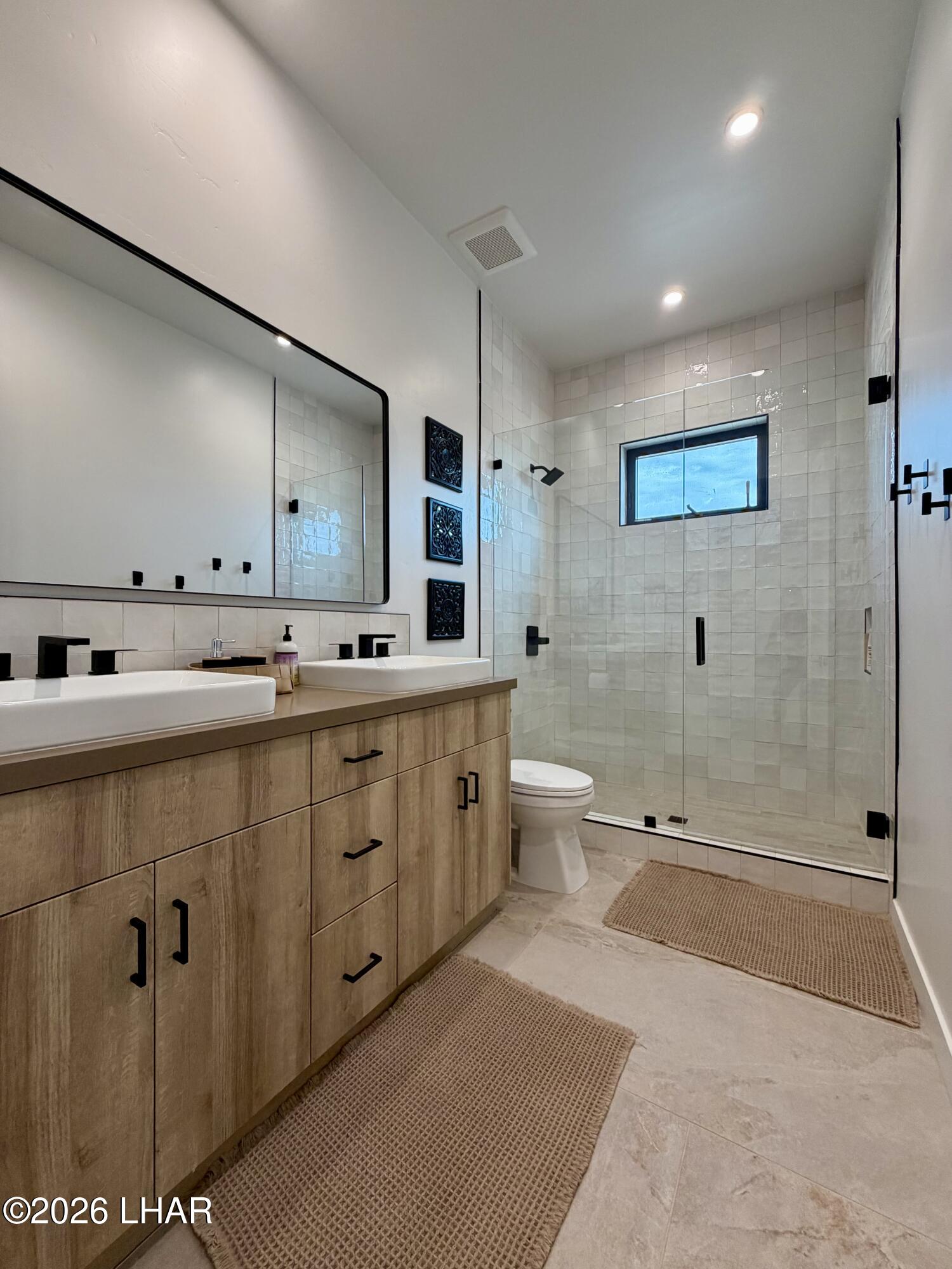 48963 Riviera Place Ehrenberg, AZ 85334 - Photo 35 of 58 a spacious bathroom with double sink and a large mirror