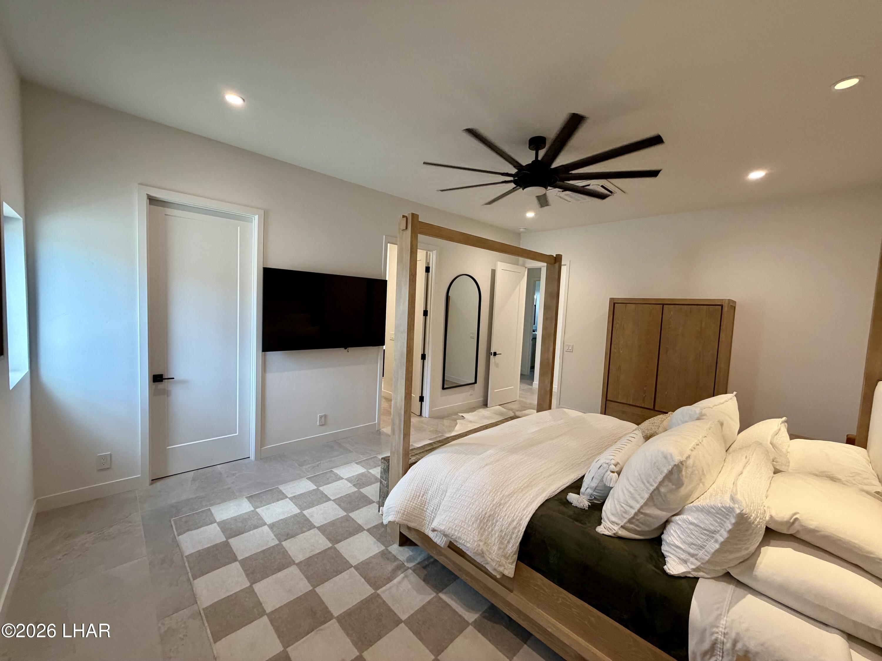 48963 Riviera Place Ehrenberg, AZ 85334 - Photo 39 of 58 a bedroom with a bed and a chandelier