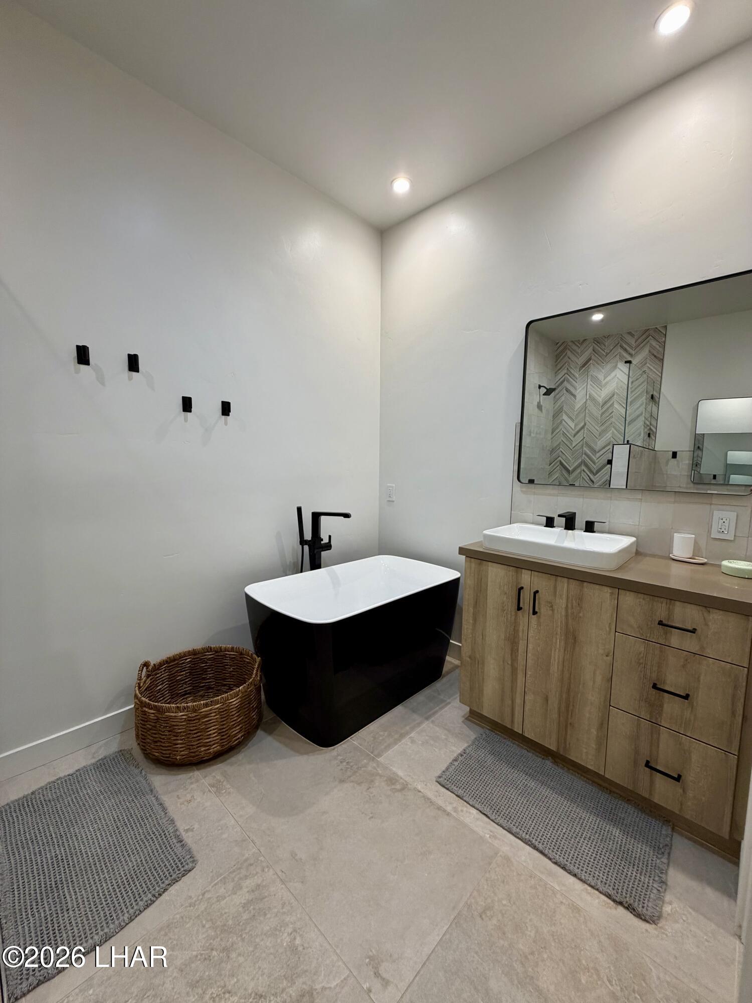 48963 Riviera Place Ehrenberg, AZ 85334 - Photo 41 of 58 a spacious bathroom with a double vanity sink mirror and bathtub