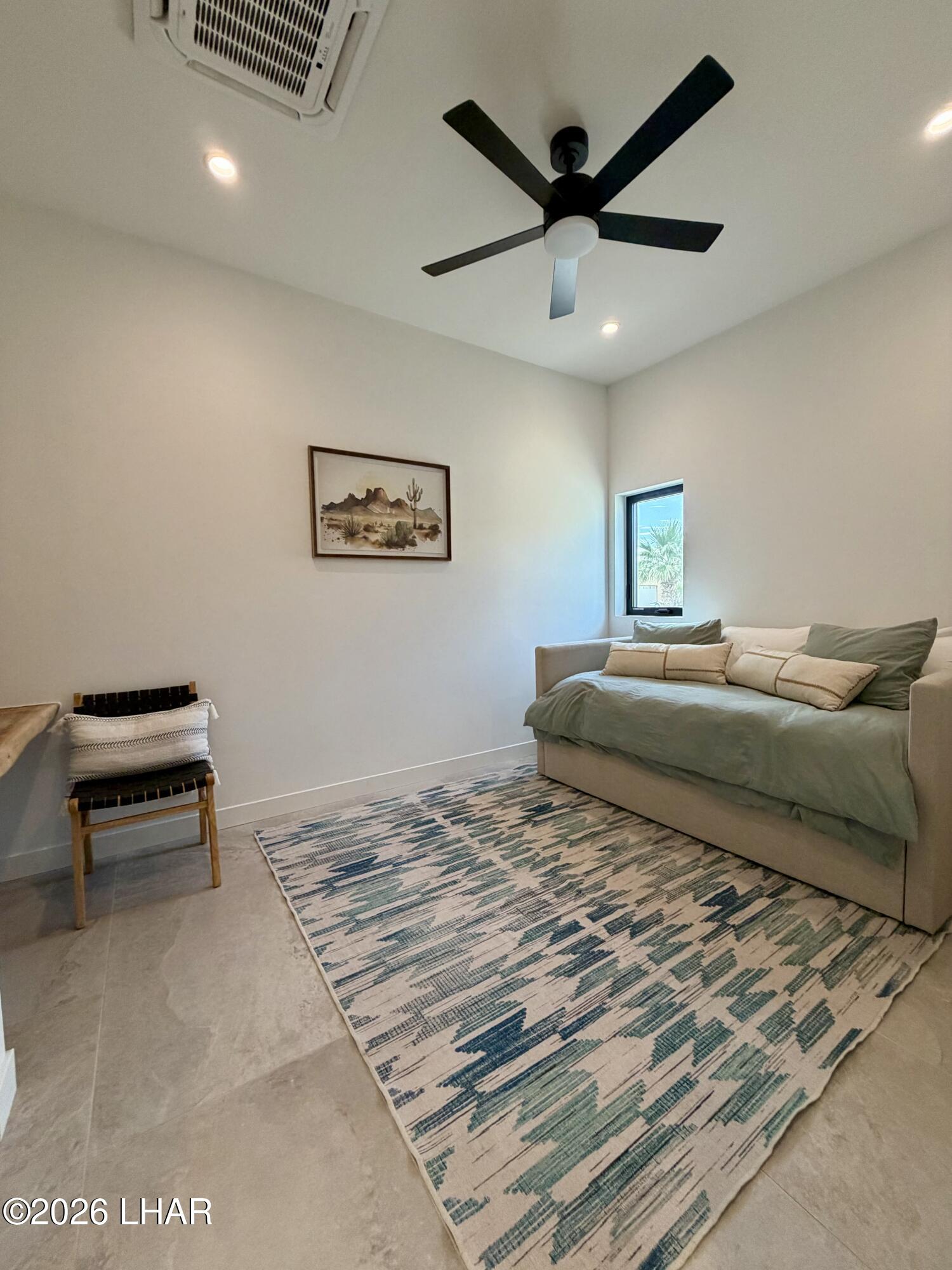 48963 Riviera Place Ehrenberg, AZ 85334 - Photo 48 of 58 a bedroom with a bed and a ceiling fan