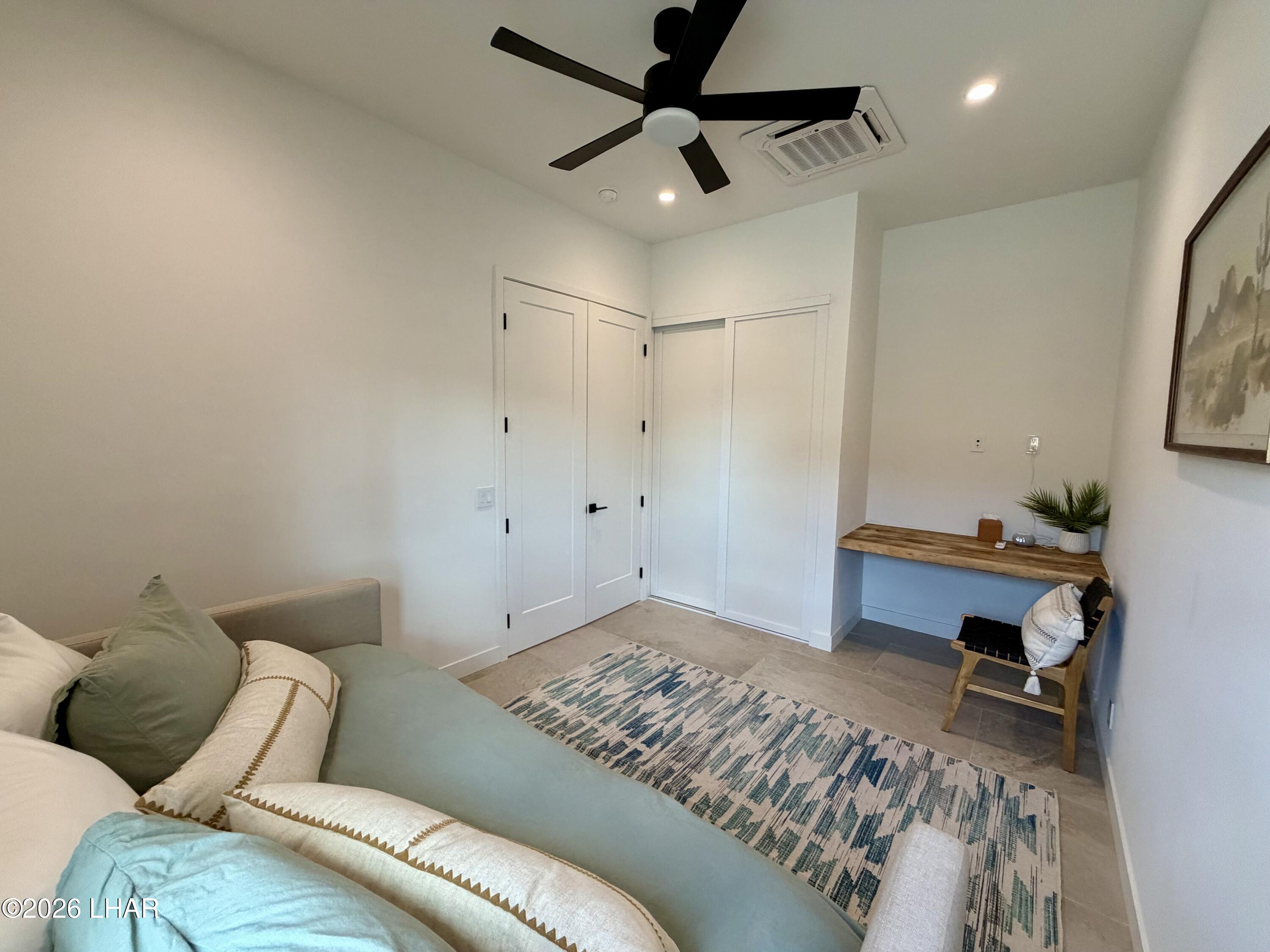 48963 Riviera Place Ehrenberg, AZ 85334 - Photo 50 of 58 a bedroom with a bed and a ceiling fan