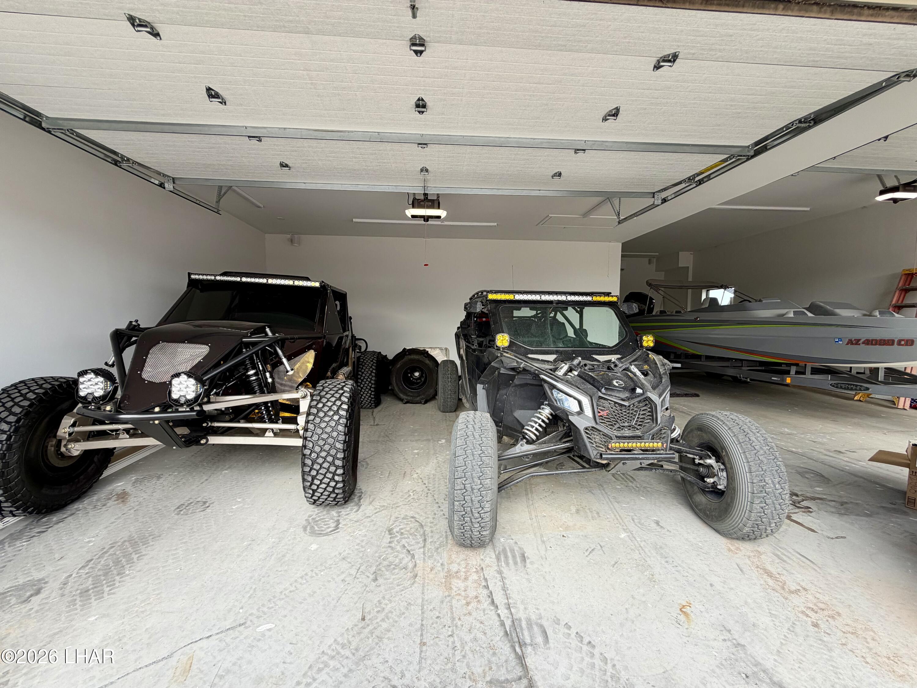 48963 Riviera Place Ehrenberg, AZ 85334 - Photo 5 of 58 a car and bike parked in a garage