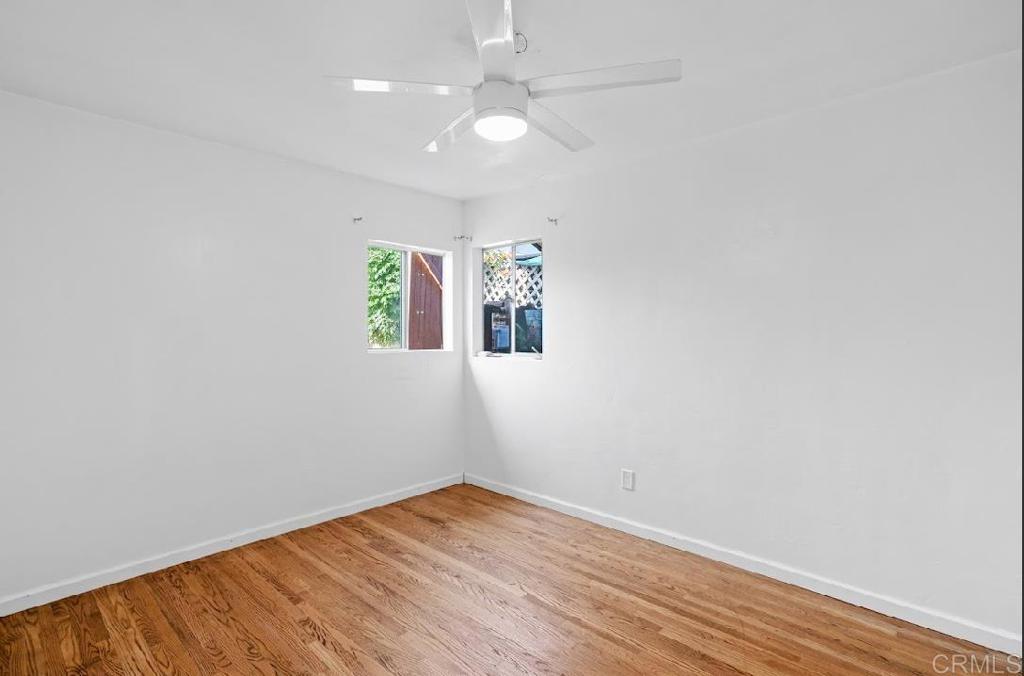3964 Delta Street San Diego, CA 92113 - Photo 15 of 42 wooden floor in an empty room with a window