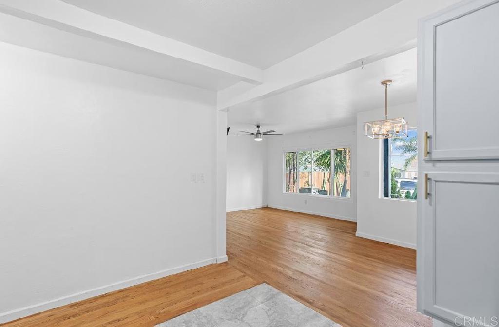 3964 Delta Street San Diego, CA 92113 - Photo 16 of 42 an empty room with wooden floor and windows