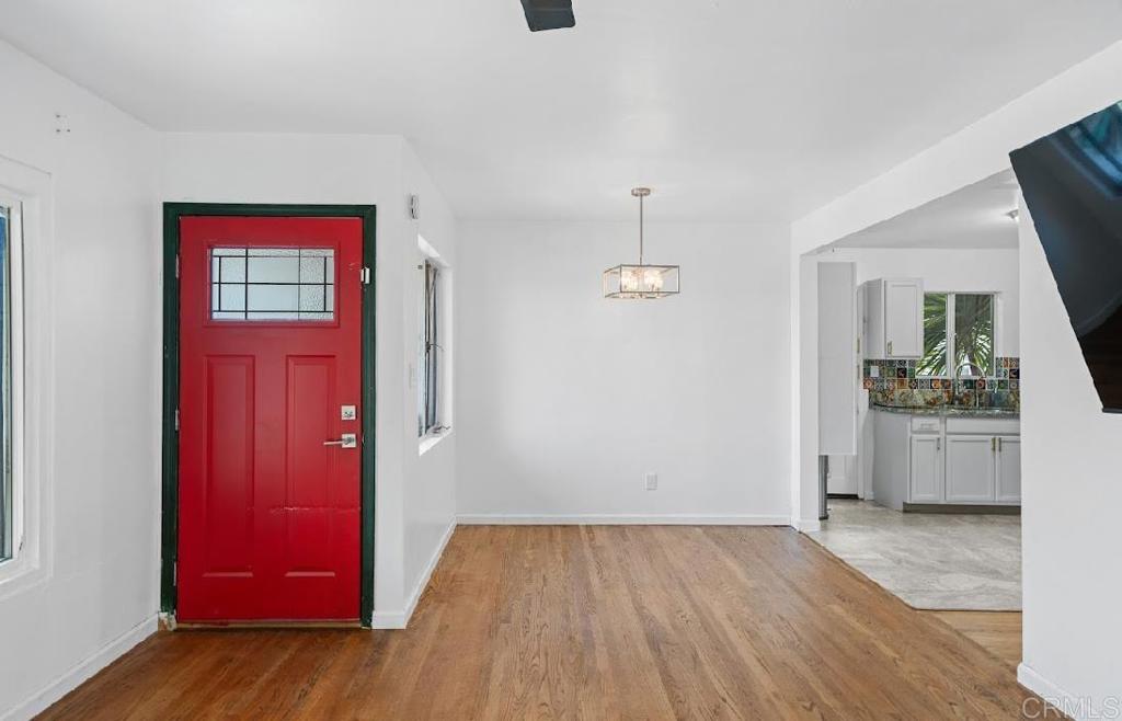 3964 Delta Street San Diego, CA 92113 - Photo 2 of 42 a view of empty room with window and wooden floor