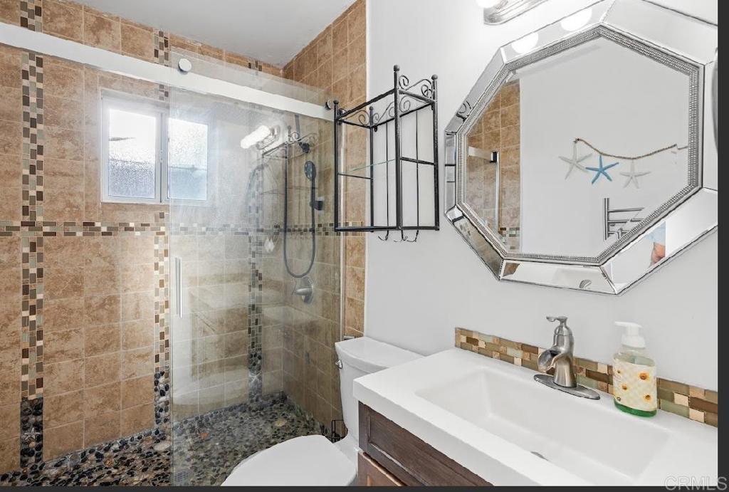 3964 Delta Street San Diego, CA 92113 - Photo 25 of 42 a bathroom with a sink toilet and shower