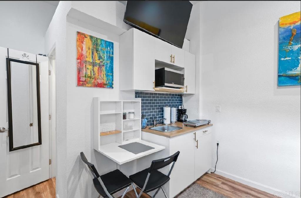 3964 Delta Street San Diego, CA 92113 - Photo 30 of 42 a workspace with furniture and fireplace