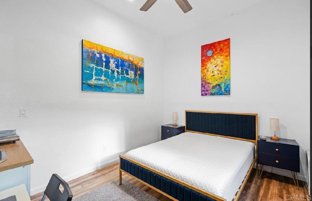 3964 Delta Street San Diego, CA 92113 - Photo 33 of 42 a bedroom with a bed and painting on the wall