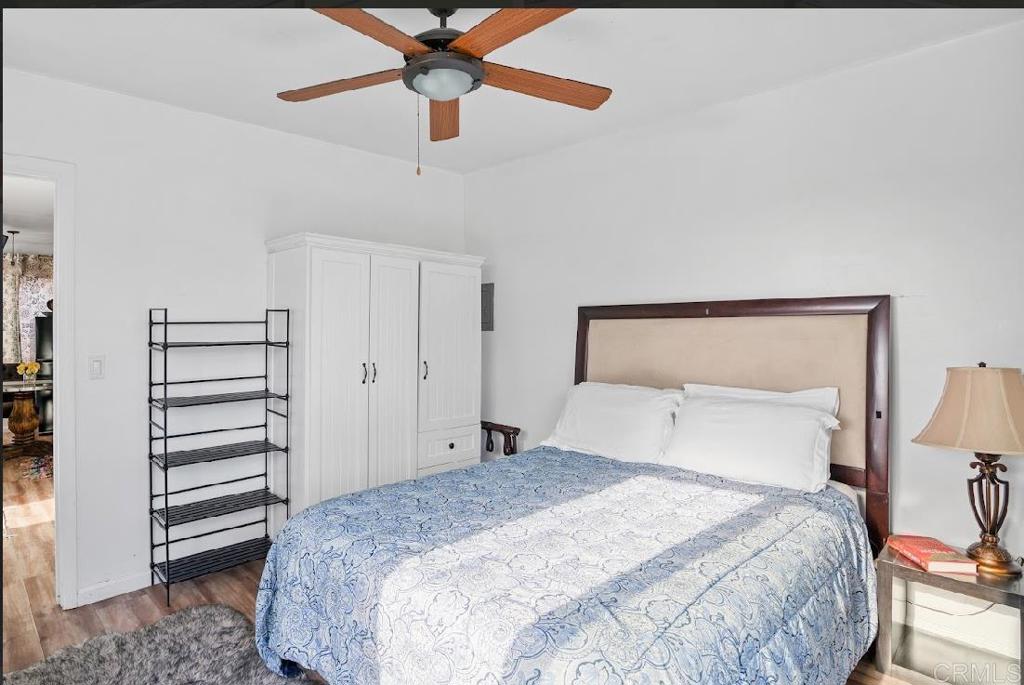 3964 Delta Street San Diego, CA 92113 - Photo 35 of 42 a bedroom with a bed and a chandelier