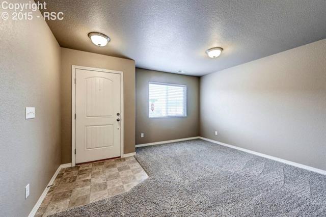 Front entry into living room.  Neutral colors provide a blank canvas for home decorators. 