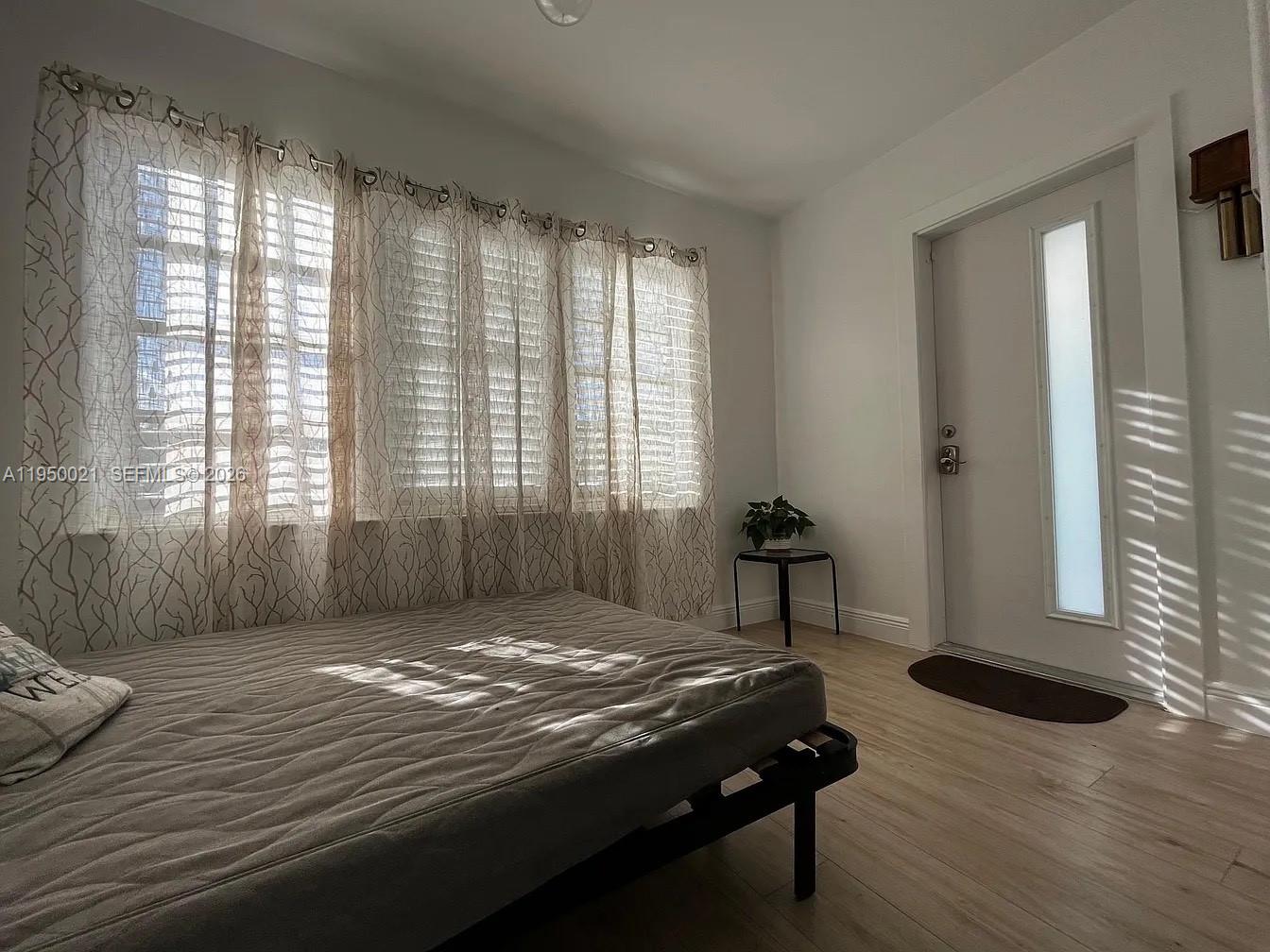 2049 Southwest 60th Court, Unit 1 Miami, FL 33155 - Photo 15 of 16 a bedroom with a bed and a window