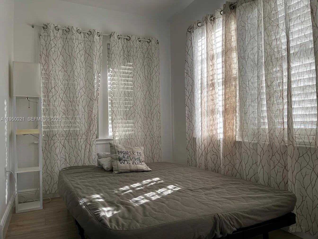 2049 Southwest 60th Court, Unit 1 Miami, FL 33155 - Photo 16 of 16 a bedroom with a bed and wooden floor