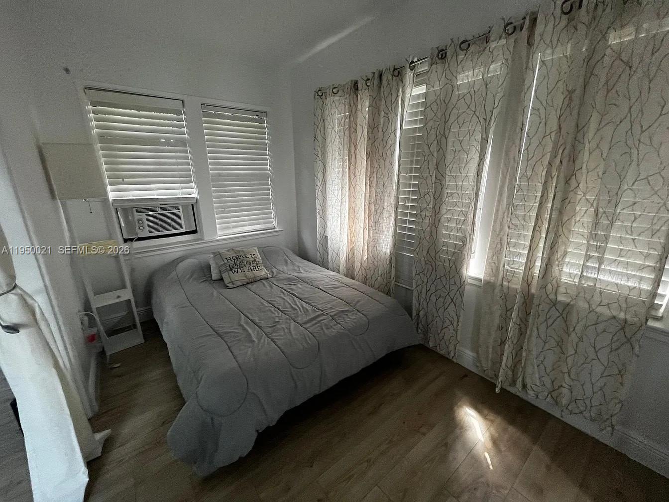 2049 Southwest 60th Court, Unit 1 Miami, FL 33155 - Photo 6 of 16 a bedroom with a bed and a window
