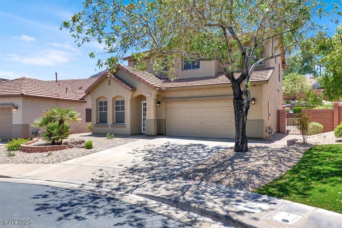 636 Pacific Cascades Drive Henderson, NV 89012 - Photo 11 of 51 View of front of house with concrete driveway, stucco siding, a tiled roof, and a garage