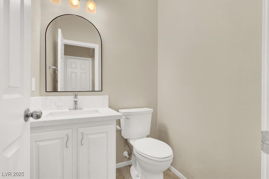 636 Pacific Cascades Drive Henderson, NV 89012 - Photo 15 of 51 Half bathroom featuring vanity and toilet