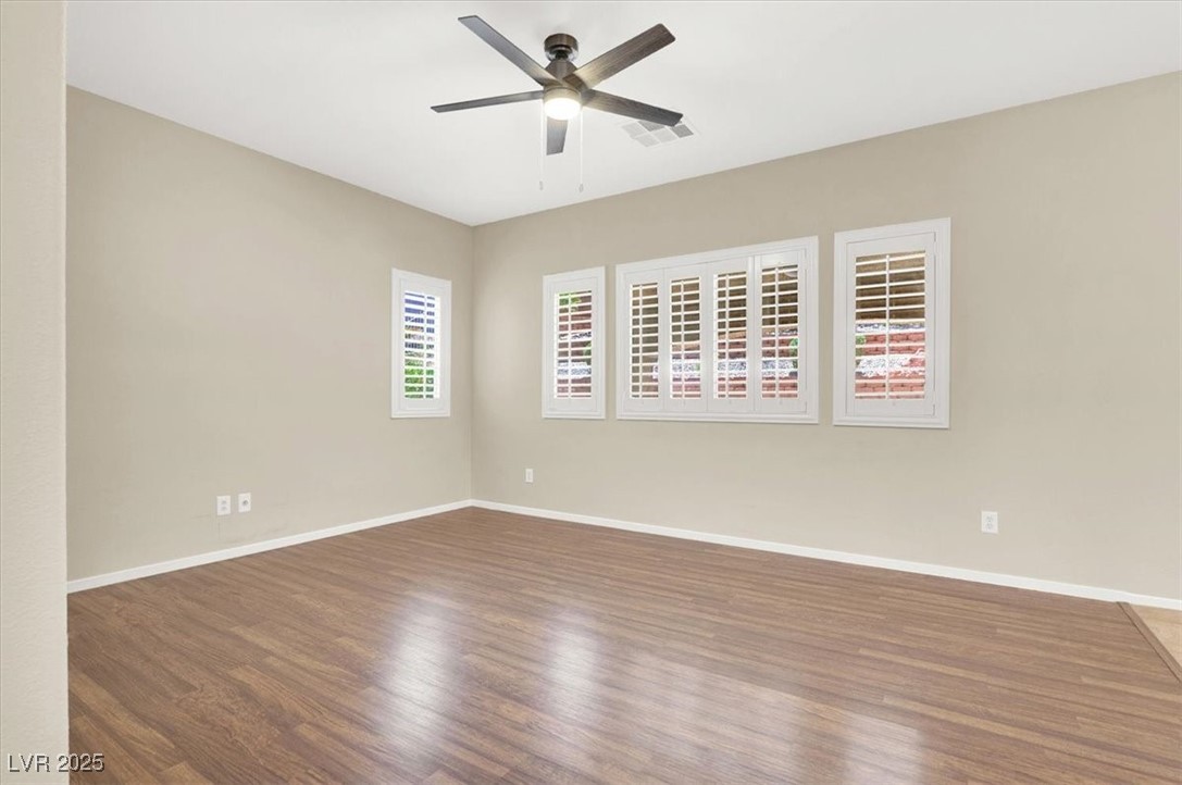 636 Pacific Cascades Drive Henderson, NV 89012 - Photo 16 of 51 Empty room featuring wood finished floors and ceiling fan