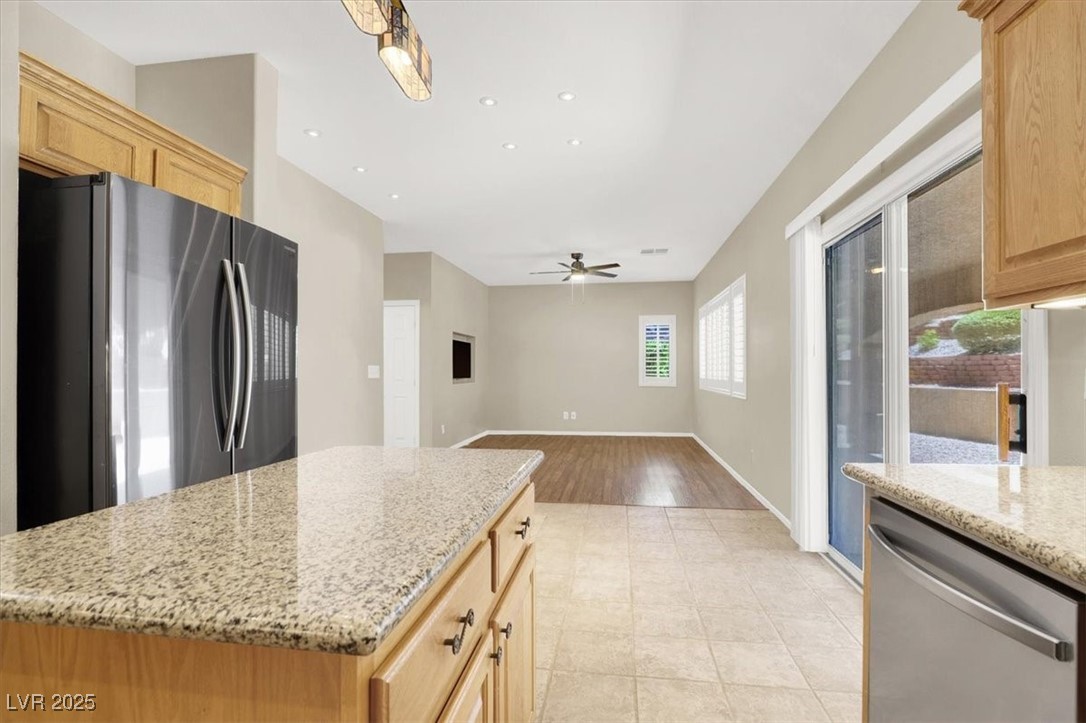 636 Pacific Cascades Drive Henderson, NV 89012 - Photo 23 of 51 Kitchen featuring stainless steel appliances, light brown cabinets, light stone countertops, and recessed lighting