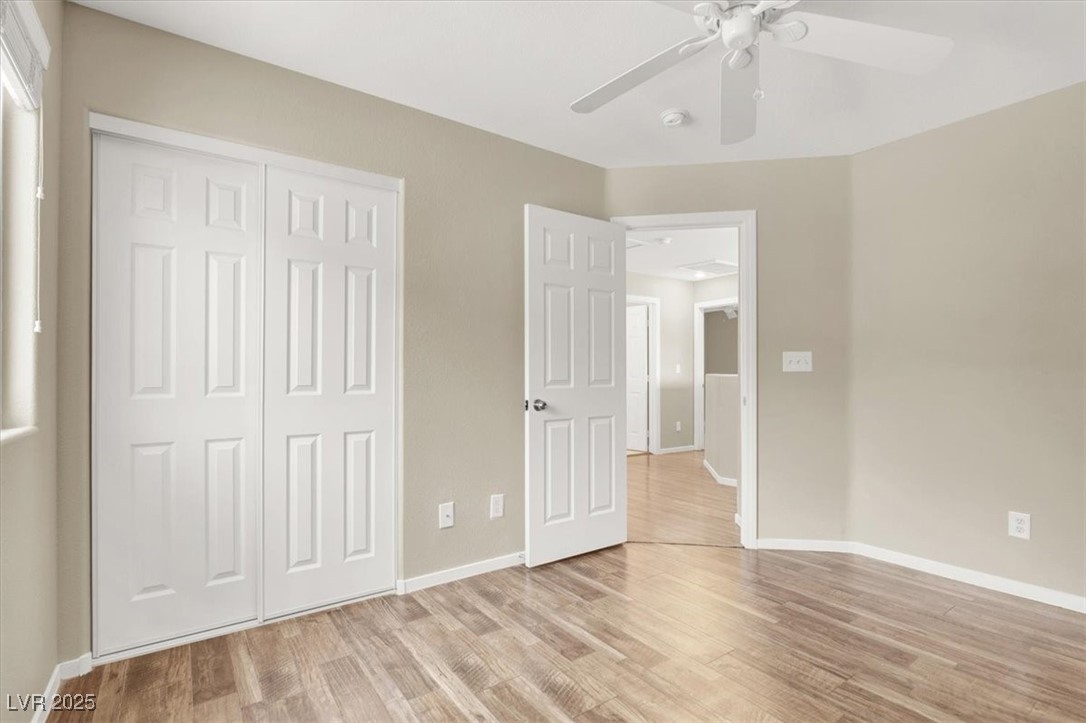 636 Pacific Cascades Drive Henderson, NV 89012 - Photo 32 of 51 Unfurnished bedroom with light wood-style floors, a ceiling fan, and a closet