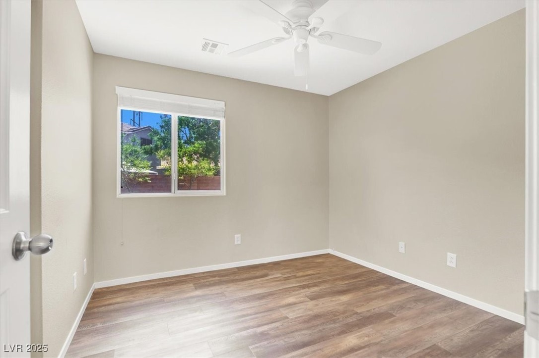 636 Pacific Cascades Drive Henderson, NV 89012 - Photo 33 of 51 Empty room with light wood-style flooring and baseboards