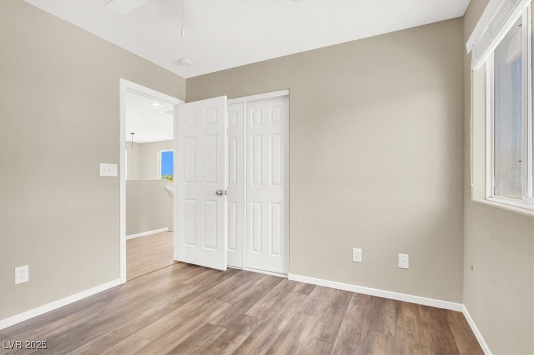636 Pacific Cascades Drive Henderson, NV 89012 - Photo 34 of 51 Unfurnished bedroom with wood finished floors, a closet, and ceiling fan