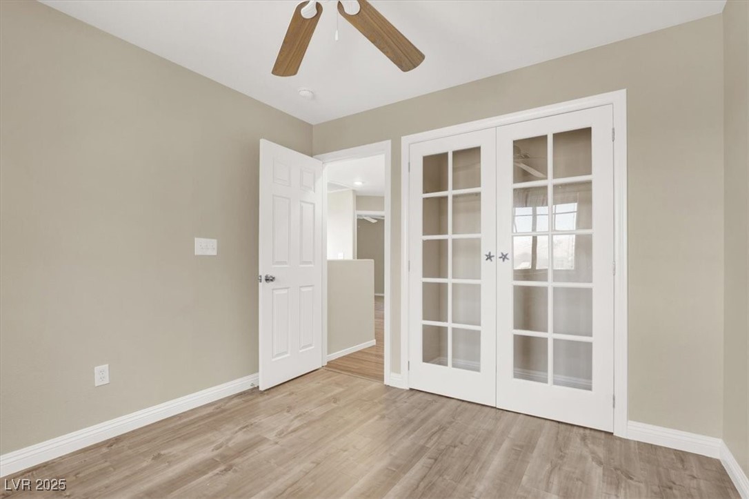 636 Pacific Cascades Drive Henderson, NV 89012 - Photo 8 of 51 Unfurnished room featuring french doors, light wood-type flooring, and ceiling fan