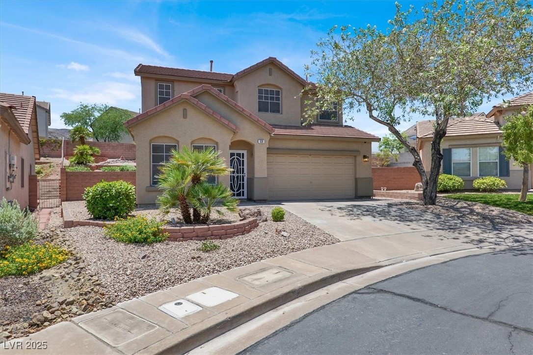 636 Pacific Cascades Drive Henderson, NV 89012 - Photo 9 of 51 View of front of house with a garage, concrete driveway, stucco siding, and a tile roof