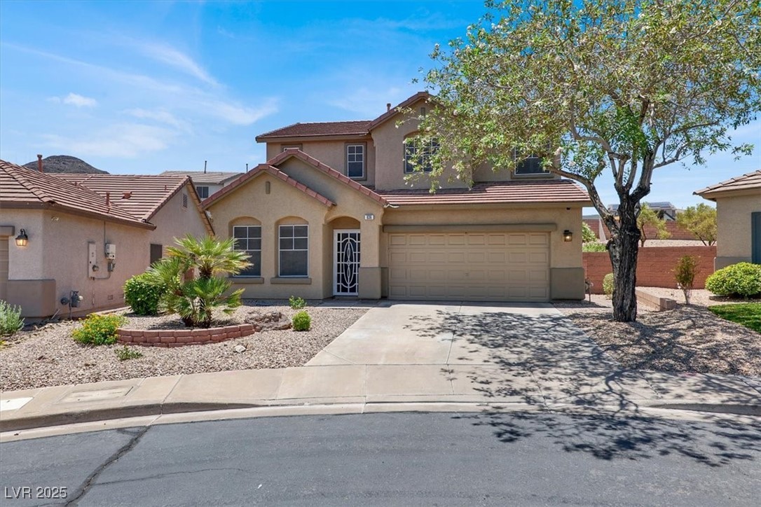 636 Pacific Cascades Drive Henderson, NV 89012 - Photo 10 of 51 View of front of property featuring driveway, stucco siding, a garage, and a tiled roof