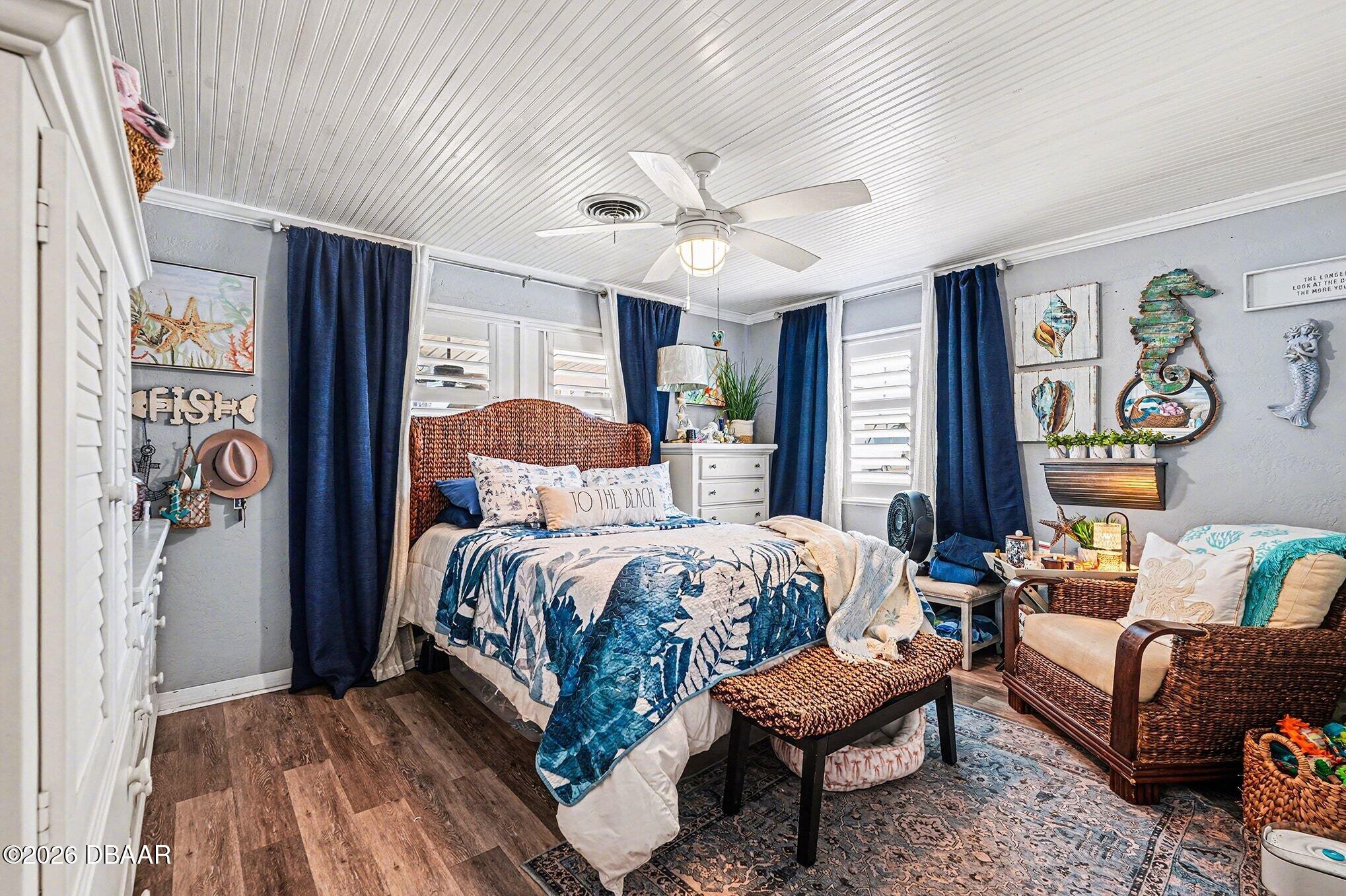 302 Riverside Drive Holly Hill, FL 32117 - Photo 12 of 23 a bedroom with a bed couch and a window