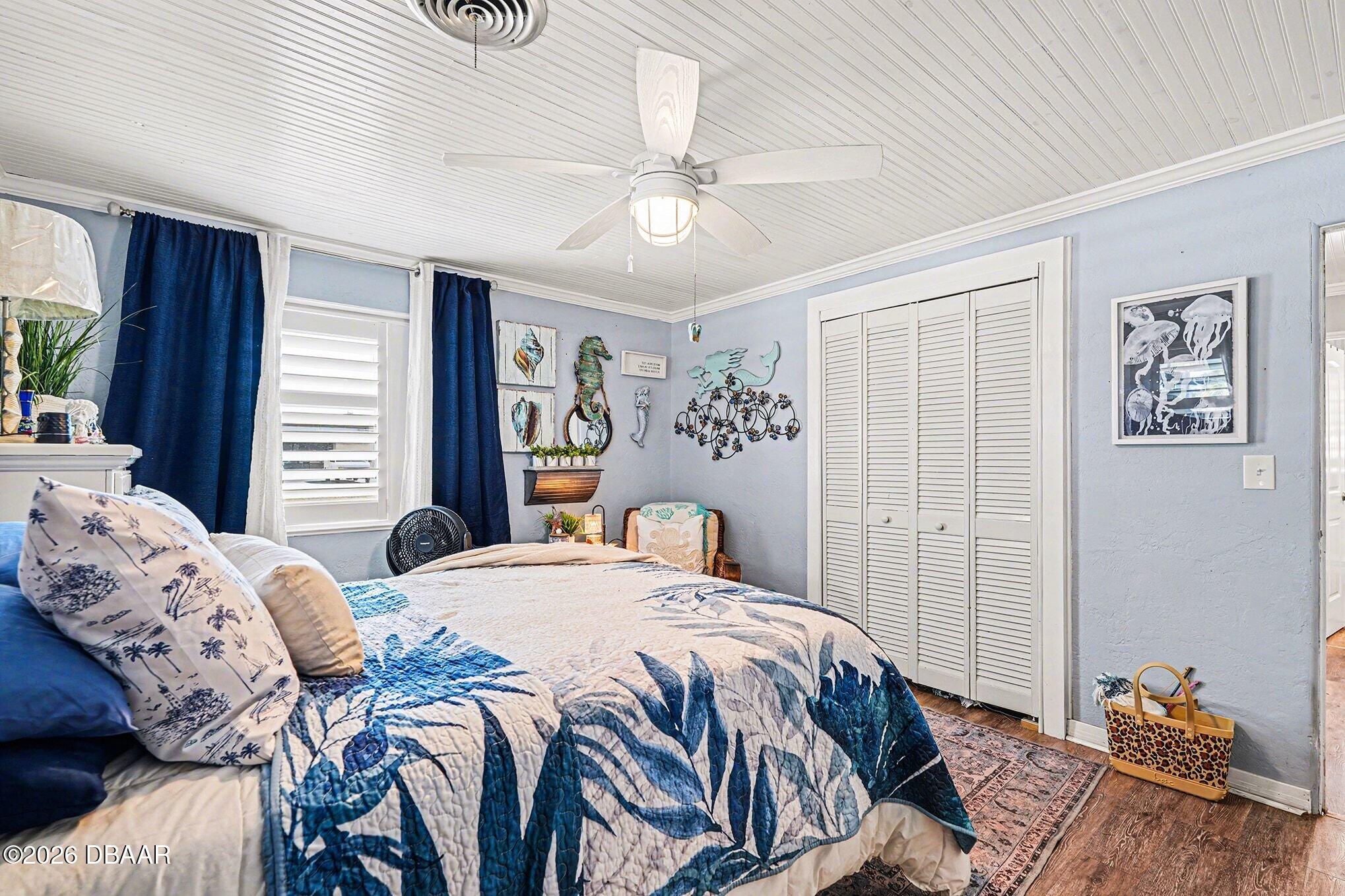 302 Riverside Drive Holly Hill, FL 32117 - Photo 13 of 23 a bedroom with a bed and wooden floor