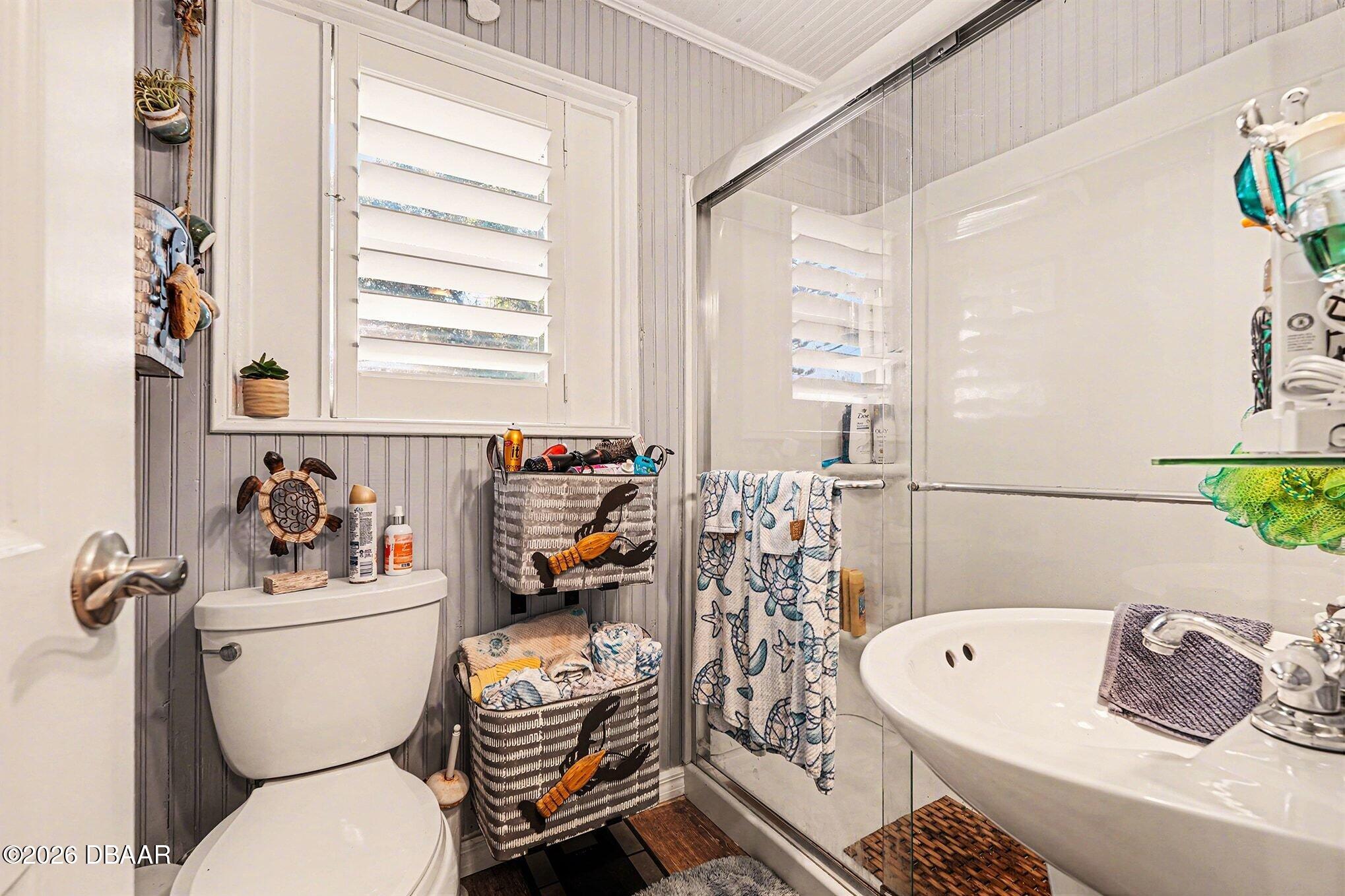302 Riverside Drive Holly Hill, FL 32117 - Photo 14 of 23 a white bath tub sitting next to a white toilet and sink