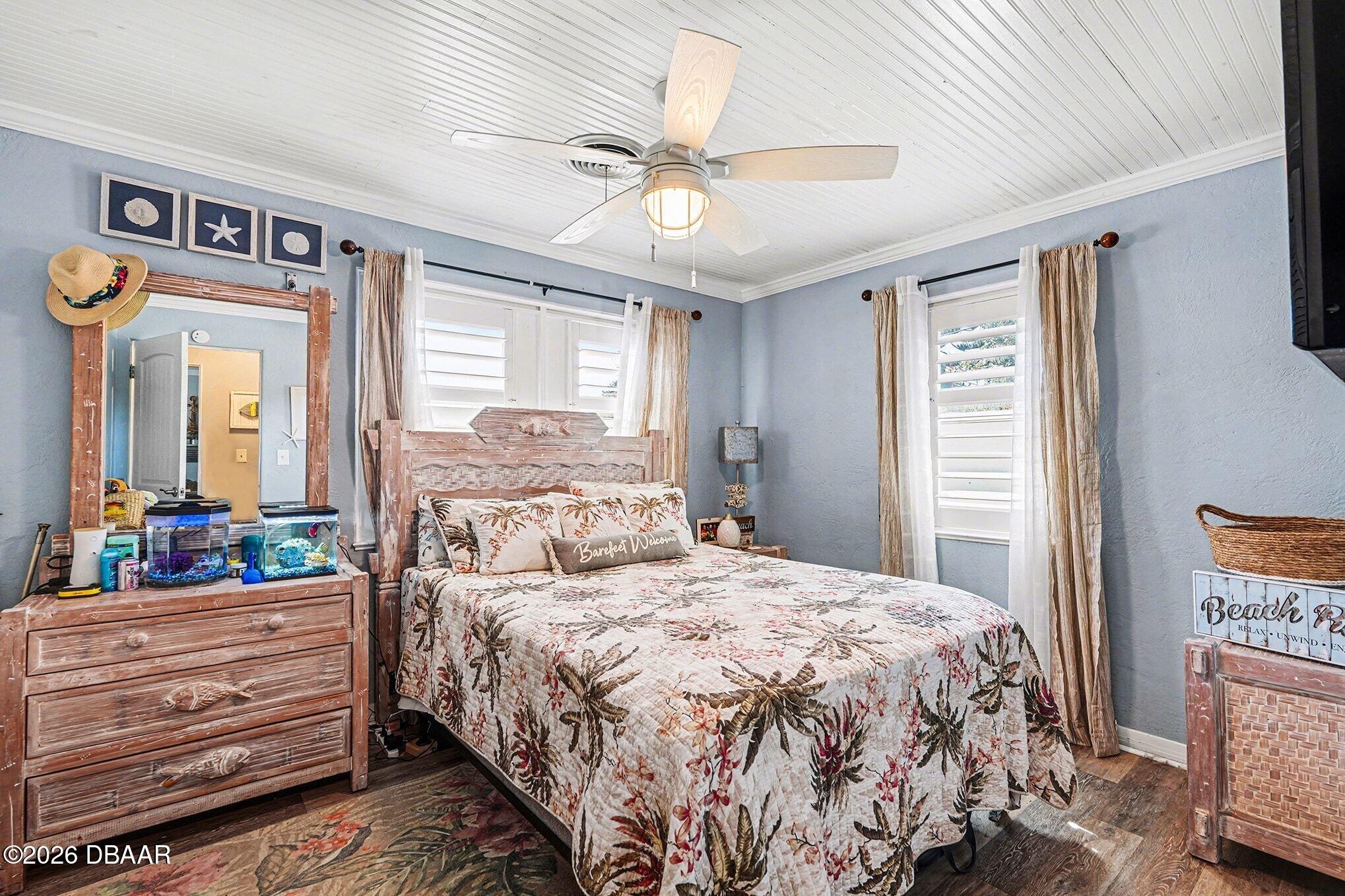 302 Riverside Drive Holly Hill, FL 32117 - Photo 15 of 23 a bedroom with a bed a dresser and a window