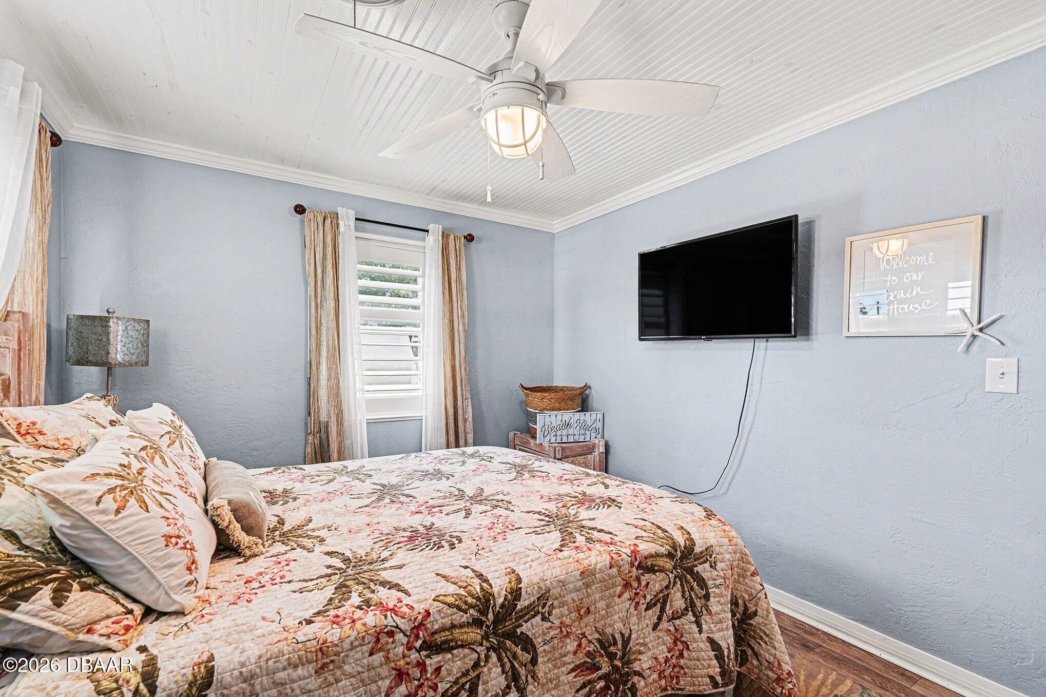 302 Riverside Drive Holly Hill, FL 32117 - Photo 16 of 23 a bedroom with a bed and a flat screen tv