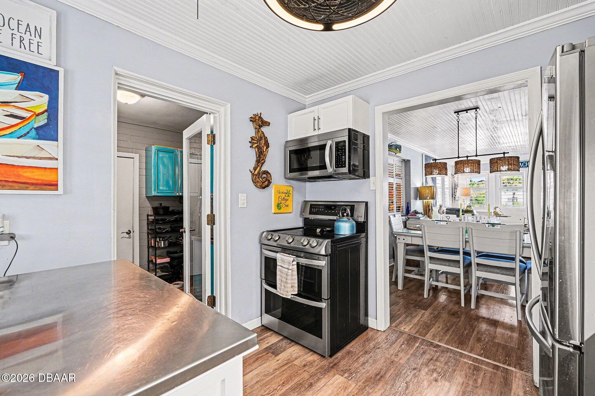 302 Riverside Drive Holly Hill, FL 32117 - Photo 9 of 23 a kitchen with a stove and a refrigerator