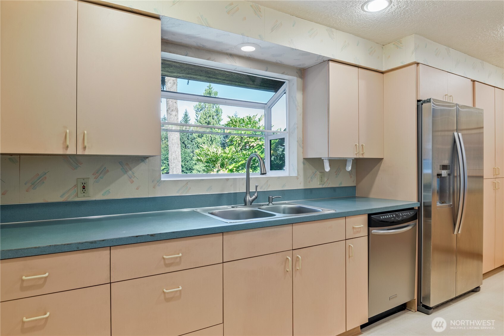 262 Sunset Drive Longview, WA 98632 - Photo 15 of 39 a kitchen with granite countertop a sink stainless steel appliances white cabinets and a window