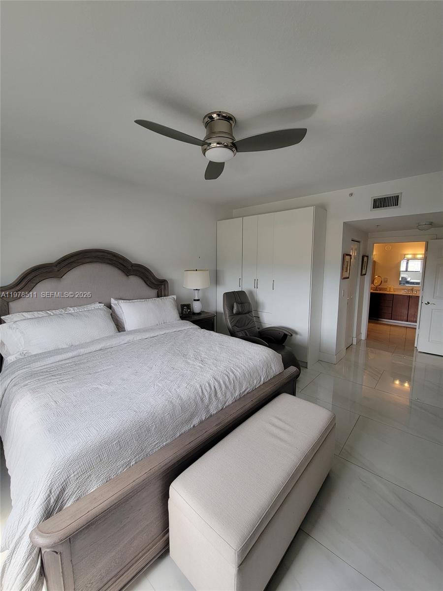 888 Douglas Road, Unit 1110 Coral Gables, FL 33134 - Photo 13 of 28 a bedroom with a bed and window