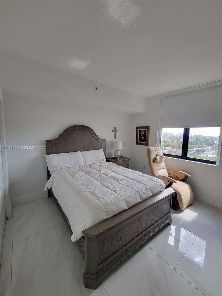 888 Douglas Road, Unit 1110 Coral Gables, FL 33134 - Photo 17 of 28 a bedroom with bed and window