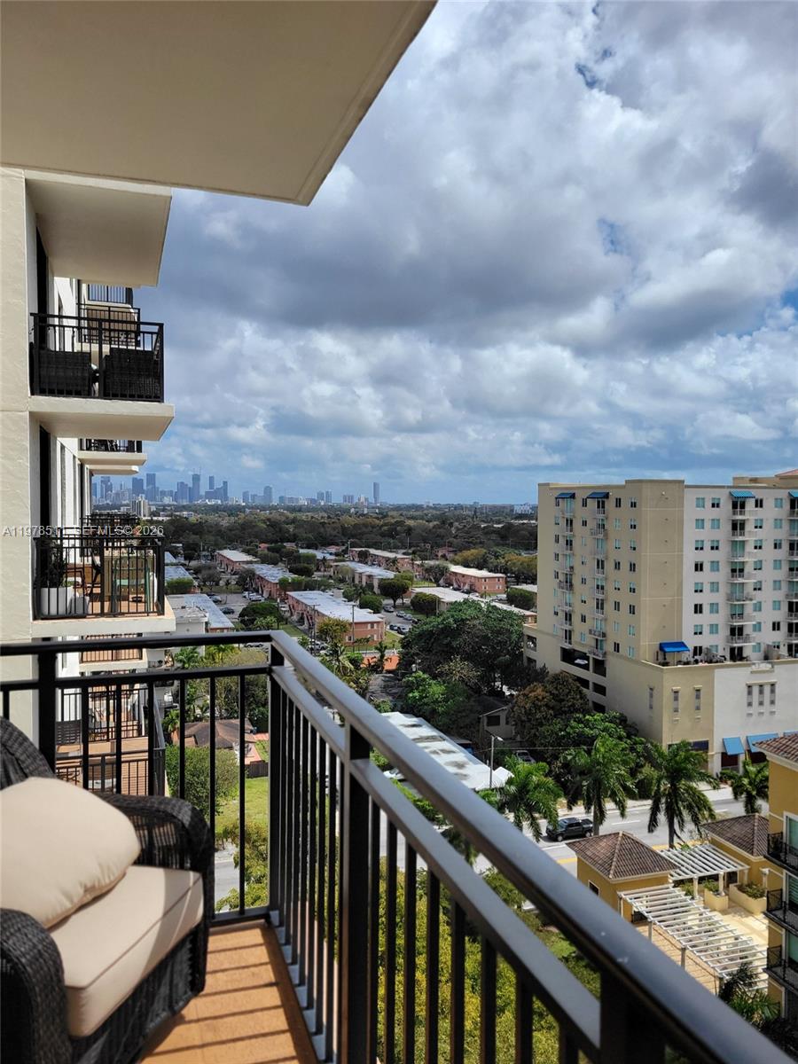 888 Douglas Road, Unit 1110 Coral Gables, FL 33134 - Photo 22 of 28 a view of a balcony with two chairs and a table