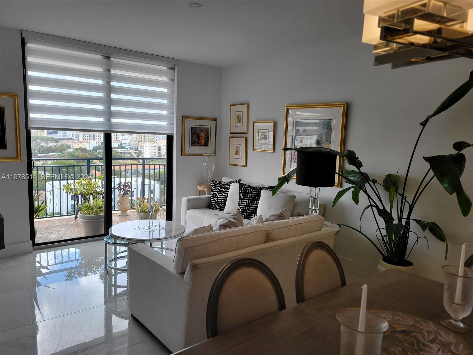 888 Douglas Road, Unit 1110 Coral Gables, FL 33134 - Photo 9 of 28 a living room with furniture and large windows