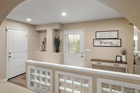 a kitchen with stainless steel appliances granite countertop a sink a stove a refrigerator cabinets a dining table and chairs